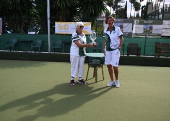 Jill watches on as Margaret takes the cup
